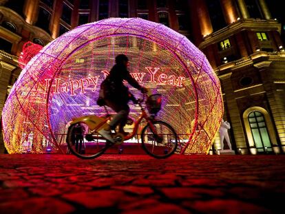 Un ciclista pasa por una calle con decoración navideña en Taiwán. 