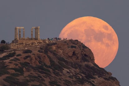 Full moon rises behind the Temple of Poseidon in Cape Sounion