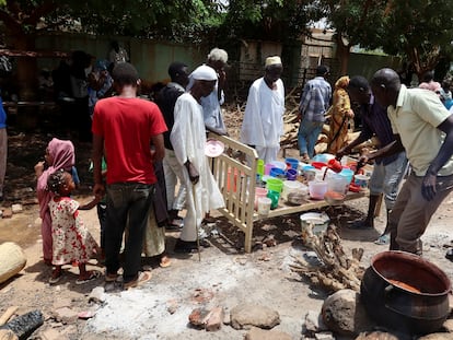 People wait for food distribution organized by volunteers in Omdurman, Sudan, September 3, 2023.