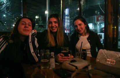 Diella (a la izquierda), en una cafetería-librería de Prístina, junto a una amiga y su hermana gemela, Enza.