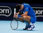 Novak Djokovic of Serbia reacts as he plays against Daniil Medvedev of Russia during a tennis match at the ATP World Finals tennis tournament at the O2 arena in London, Wednesday, Nov. 18, 2020. (AP Photo/Frank Augstein)