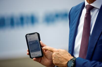 Timotheus Hoettges, CEO de Deutsche Telekom AG, con un móvil provisto de Corona Warn App, la app alemana de rastreo.