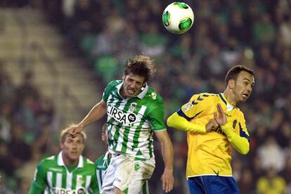El bético Rubén Pérez salta por el balón con Deivid.