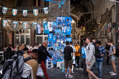 Camisetas y banderolas del SSC Napoli en una de las calles del centro de la ciudad italiana, tras la victoria del equipo de fútbol en el campeonato de la serie A en 2023.