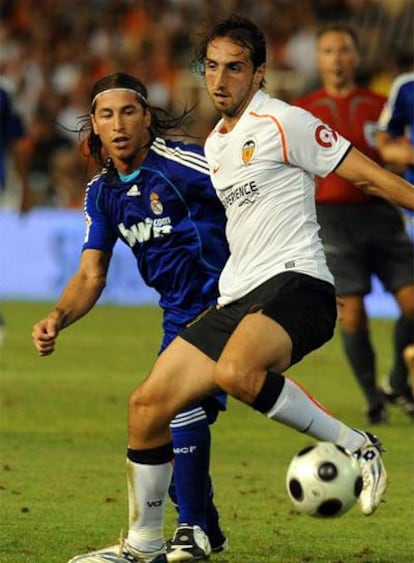 El jugador del Valencia Moretti lucha el balón con Ramos, del Real Madrid, durante el partido de ida de la Supercopa.