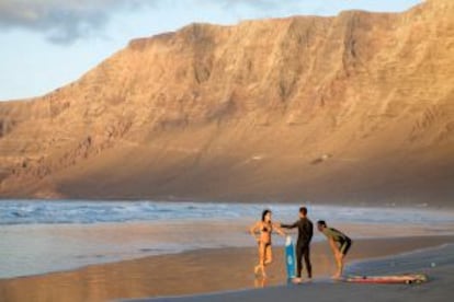 Surferos en el arenal de Famara, en Lanzarote.