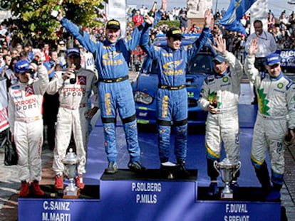 El podio tras la carrera de ayer. A la izquierda, Marc Martí, su copiloto, y Carlos Sainz.