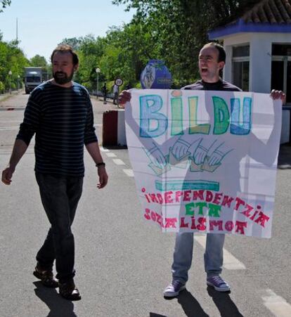 Ander Errandonea, sujeta una pancarta a favor de Bildu, junto a uno de sus hermanos, tras salir hoy de la cárcel de Herrera de la Mancha.