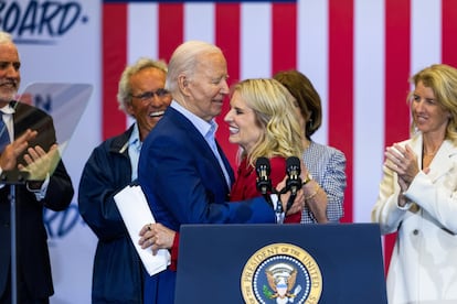 US President Joe Biden (C-L), hugs Kerry Kennedy (C-R) after she and other Kennedy family members