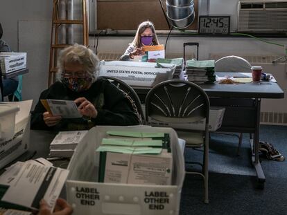 Trabajadores procesan las papeletas del voto anticipado en Lansing, Michigan.