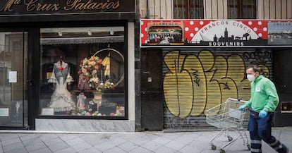 A man walks past closed stores during the coronavirus lockdown in Spain.