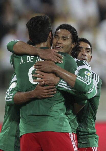 Carlos Peña abraza a sus compañeros para celebrar uno de los goles ante Nueva Zelanda