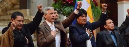 Evo Morales (second from right) gestures along with members of his Cabinet and supporters on Tuesday after signing a decree to expropriate REEs stake in the local power utility,