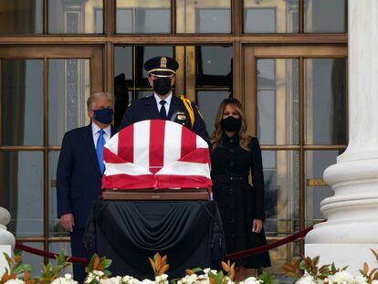 President Donald Trump turns to his left as protesters yell from a block away while he and first lady Melania Trump pay respects as Justice Ruth Bader Ginsburg lies in repose at the Supreme Court building on Thursday, Sept. 24, 2020, in Washington. Ginsburg, 87, died of cancer on Sept. 18. (AP Photo/J. Scott Applewhite)