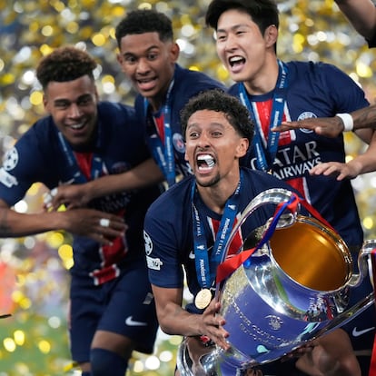 PSG's team captain Marquinhos holds the trophy after winning the Champions League final soccer match between Paris Saint-Germain and Inter Milan at the Allianz Arena in Munich, Germany, Saturday, May 31, 2025. (AP Photo/Luca Bruno)