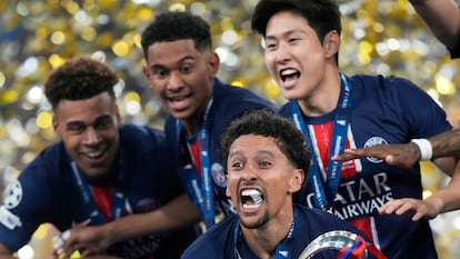 PSG's team captain Marquinhos holds the trophy after winning the Champions League final soccer match between Paris Saint-Germain and Inter Milan at the Allianz Arena in Munich, Germany, Saturday, May 31, 2025. (AP Photo/Luca Bruno)