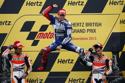 Yamaha MotoGP rider Jorge Lorenzo celebrates winning the British Grand Prix with Honda riders Marc Marquez (l) and Dani Pedrosa also on the podium.