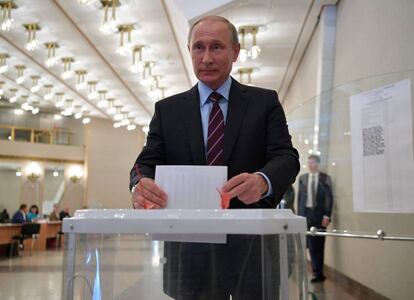 Vladimir Putin coloca su voto en la urna.