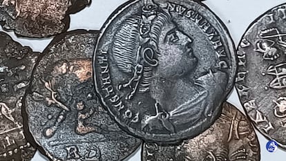 A picture made available by the Italian Culture Minister showing some of the discovered ancient bronze coins.