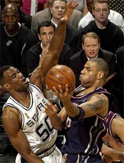 El jugador de los Nets de Nueva Jersey Martin (dcha.) pelea el balón con David Robinson, de los Spurs.