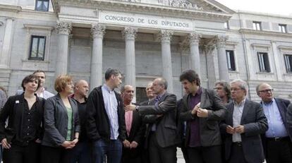 Joan Ridao (ERC, centro), flanqueado por los portavoces de Bildu, Oskar Matute (izquierda) y Pello Urizar, en la puerta del Congreso.