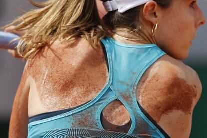 Detalle de la espalda de la tenista Alize Cornet cubierta de arena tras una caída durante su encuentro disputado ante la tenista eslovaca Viktoria Kuzmova, el 27 de mayo de 2019.