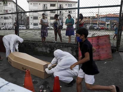 Empleados de una funeraria recogen en una favela de Río de Janeiro el cadáver de un hombre que, según los vecinos, tardaron 30 horas en retirar.