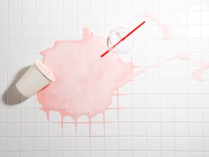 Spilt strawberry shake on tiled floor