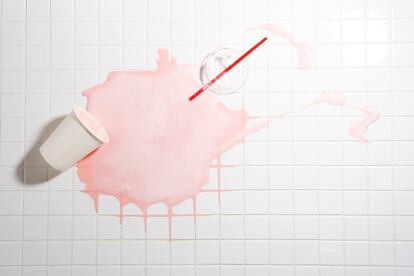 Spilt strawberry shake on tiled floor