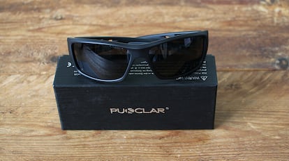 Sports sunglasses on a wooden table.