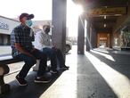 CALEXICO, CALIFORNIA - JULY 24: Men wear face masks as they wait for a shop to open near the U.S.-Mexico border in Imperial County, which has been hard-hit by the COVID-19 pandemic, on July 24, 2020 in Calexico, California. Imperial County currently suffers from the highest death rate and near-highest infection rate from COVID-19 in California. The rural county, which is 85 percent Latino, borders Mexico and Arizona and endures high poverty rates and air pollution while also being medically underserved. In California, Latinos make up about 39 percent of the population but account for 55 percent of confirmed coronavirus cases.   Mario Tama/Getty Images/AFP
== FOR NEWSPAPERS, INTERNET, TELCOS & TELEVISION USE ONLY ==