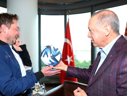 Turkey's President Tayyip Erdogan presents a ball as he meets with Tesla CEO Elon Musk in New York, U.S., September 17, 2023.