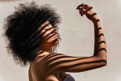 Portrait of young woman with shadow on her body