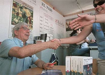 Mario Vargas Llosa firma ejemplares, ayer, en la caseta de EL PAÍS, en la Feria del Libro.

 / GORKA LEJARCEGI