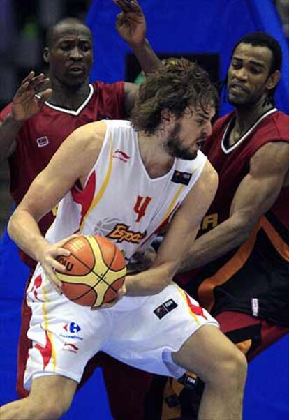 Pau Gasol se intenta zafarse del marcaje de los jugadores congoleños Gomes y Mingas.