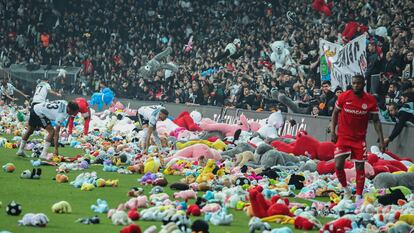 Fans throw toys onto the pitch during the Turkish Super League soccer match between Besiktas and Antalyaspor at the Vodafone stadium in Istanbul, Turkey, Sunday, Feb. 26, 2023. During the match, supporters threw a massive number of soft toys to be donated to children affected by the powerful earthquake on Feb. 6 on southeast Turkey. (AP Photo)