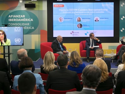 Coloquio entre los exsecretarios generales iberoamericanos, Rebeca Grynspan (en la pantalla) y Enrique V. Iglesias (izquierda en el escenario), con Andrés Allamand (en el centro), actualmente en el cargo, y Javier Moreno (derecha), exdirector de EL PAÍS, este martes en Madrid.