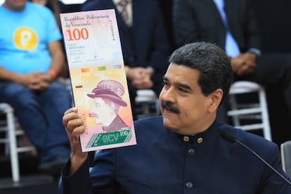 Venezuela’s President Maduro with an image of the new Venezuelan banknote, after getting rid of three zeros from the currency.