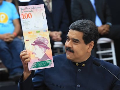 Venezuela’s President Maduro with an image of the new Venezuelan banknote, after getting rid of three zeros from the currency.