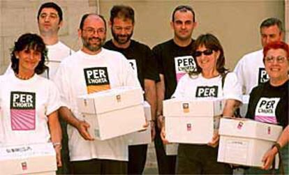 Integrantes de la comisión promotora de la iniciativa legislativa popular, con las cajas que contenían las firmas, ayer, en las Cortes.