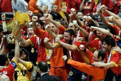 Garralda, el capitán de la selección española de balonmano, muestra el trofeo de campeón mundial al resto de sus compañeros.