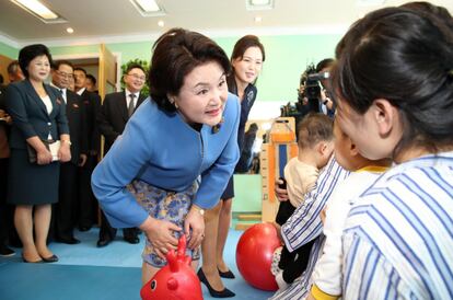 La primera dama surcoreana, Kim Jung-sook (c-i), conversa con la primera dama norcoreana, Ri Sol-ju (c-d), durante su visita al hospital pediátrico Ongyu en Pionyang.