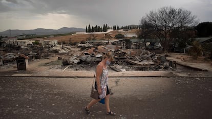 A woman walks through the Lazy Days in Spain – Pueblo Fiesta holiday park in Mollina.