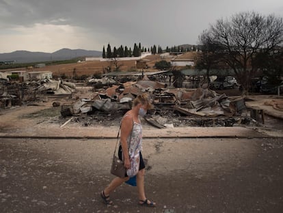 A woman walks through the Lazy Days in Spain – Pueblo Fiesta holiday park in Mollina.