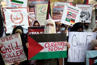 Pakistani people hold placards during a protest against Israeli airstrikes and to show solidarity with Palestinian people in Gaza, in Lahore, Pakistan, Saturday, Jan. 27, 2024. (AP Photo/K.M. Chaudary)
