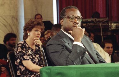 FILE - In this Sept. 10, 1991, file photo, then-Supreme Court Justice Nominee Clarence Thomas and his wife Virginia listen during his nomination hearing before the Senate Judiciary Committee on Capitol Hill in Washington. Washington knows how to do big hearings. Dramatic congressional hearings are something of a Washington art form, a rite of democracy carefully crafted for the cameras. Suspense is building as fired FBI Director James Comey prepares to claim the microphone June 8, 2017, in an austere, modern hearing room of the Hart Senate Office Building. (AP Photo/Doug Mills, File)