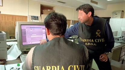 Dos agentes de la Guardia Civil rastrean delitos informáticos cometidos a través de Internet.