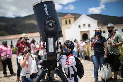 A child dressed as an astronaut looks through a telescope at the Astronomy Festival in Villa de Leyva, Colombia, 2021.