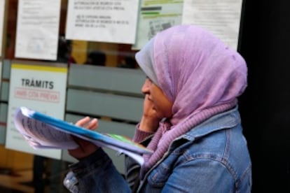 A Muslim migrant stands in line in an immigration office in Barcelona in 2010.