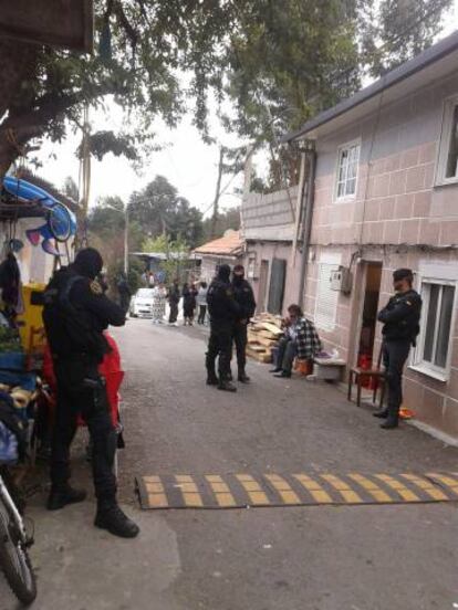 Agentes y vecinos en una calle de O Vao, durante la operaci&oacute;n antidroga.